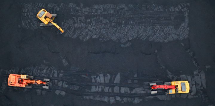 Esta foto aérea muestra excavadoras transfiriendo carbón en un puerto de Lianyungang, en la provincia oriental china de Jiangsu.