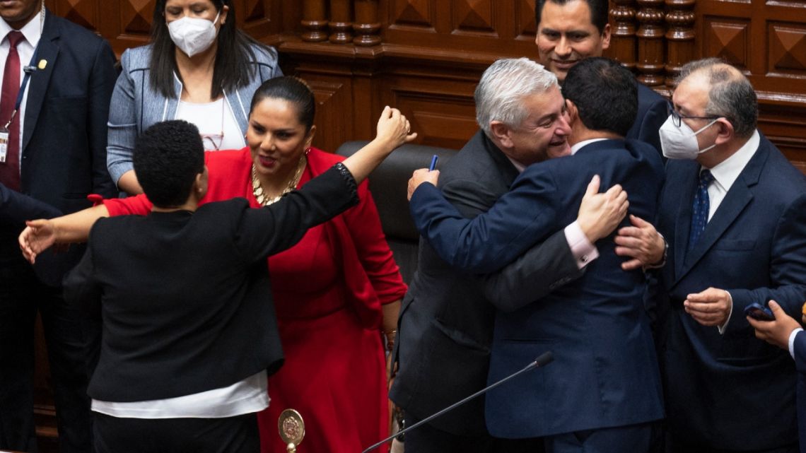 Board of directors of the Peruvian Congress is congratulated by congress members after the vote for the impeachment of President Pedro Castillo in Lima, on December 7, 2022.