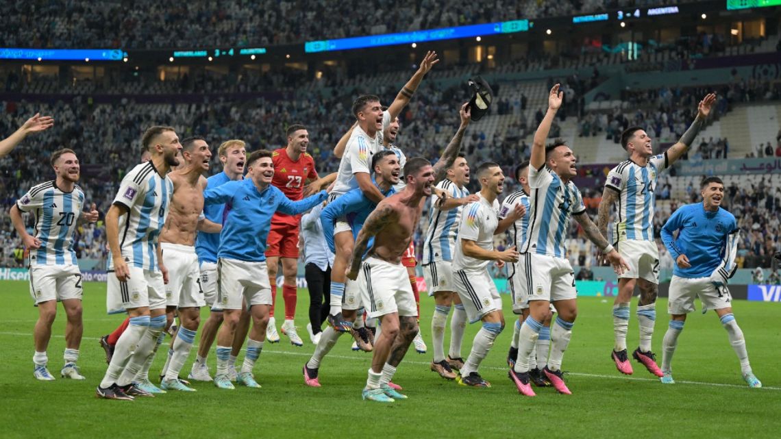 Argentina's players celebrate their victory in the Qatar 2022 World Cup quarter-final football match between The Netherlands and Argentina at Lusail Stadium, north of Doha on December 9, 2022. 