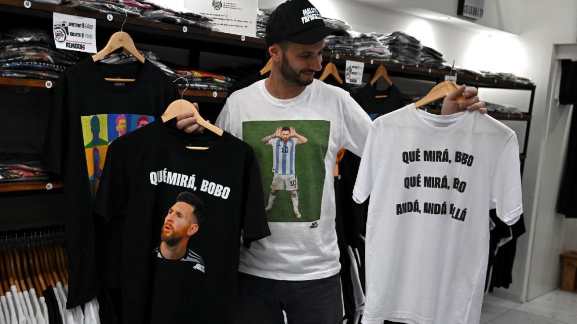 A man holds t-shirts with an image of Lionel Messi and his now infamous phrase at a store in Buenos Aires, on December 12, 2022. 