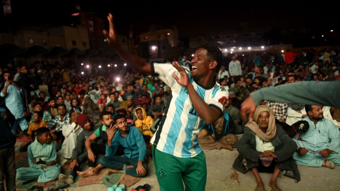 Pakistani football fans dance as they watch the live broadcast of the Qatar 2022 World Cup football semi-final match between Argentina and Croatia in the Lyari neighbourhood of Karachi on December 14, 2022.