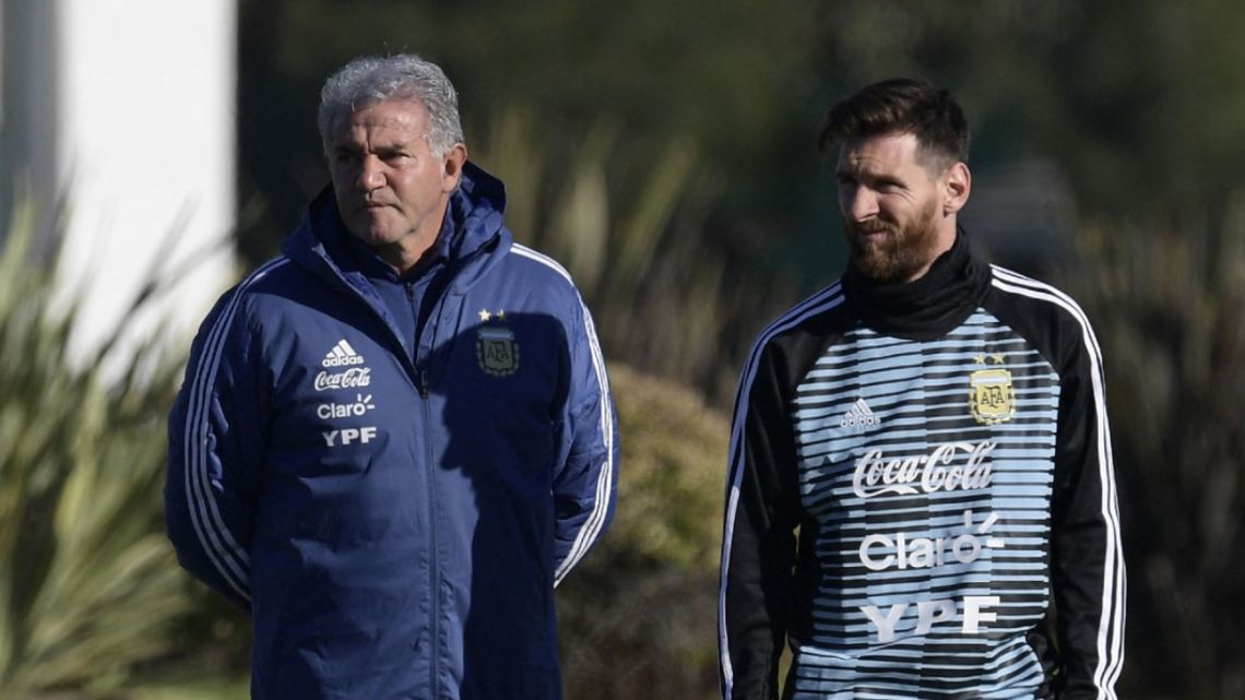 In this file photo taken on May 22, 2018, Lionel Messi walks next to Jorge Burruchaga at a training pitch at AFA headquarters in Ezeiza, Buenos Aires Province.