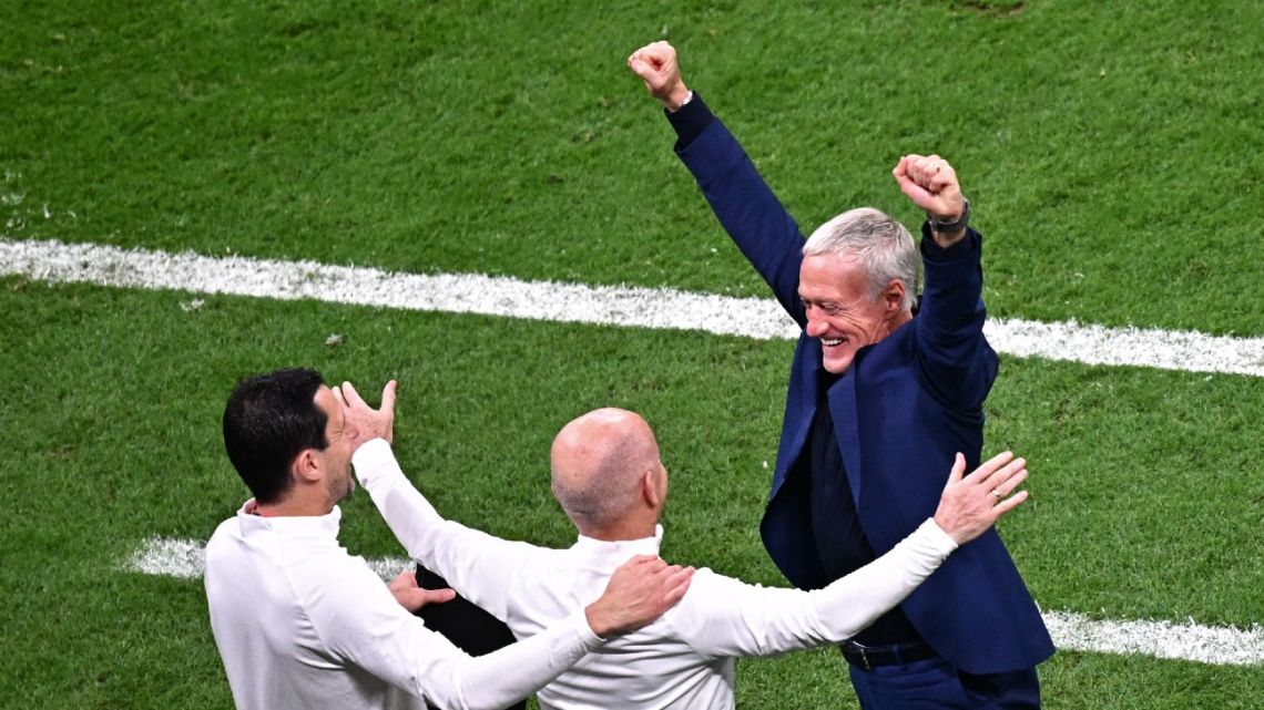France's coach Didier Deschamps celebrates with assistant coach Guy Stephan and France's goalkeeping coach Franck Raviot after they won the Qatar 2022 World Cup semi-final football match between France and Morocco at the Al-Bayt Stadium in Al Khor, north of Doha on December 14, 2022. 