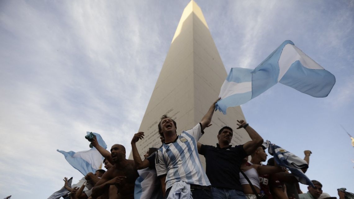 Fans of Argentina celebrate their team's victory after the Qatar 2022 World Cup semifinal football match between Croatia and Argentina at the Obelisk in Buenos Aires on December 13, 2022. 