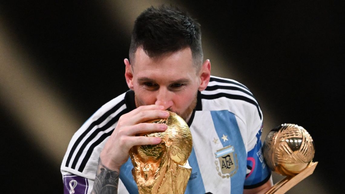 Argentina's captain and forward #10 Lionel Messi kisses the FIFA World Cup Trophy during the trophy ceremony after Argentina won the Qatar 2022 World Cup final football match between Argentina and France at Lusail Stadium in Lusail, north of Doha on December 18, 2022. 