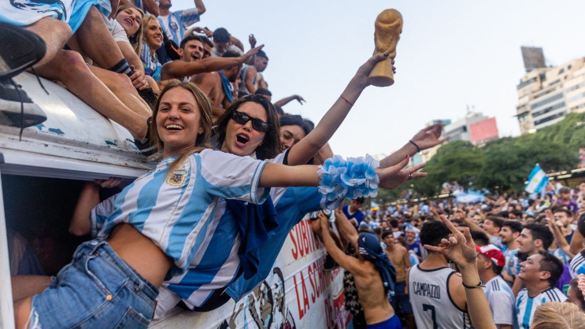 Fans of Argentina celebrate winning the Qatar 2022 World Cup against France at the Obelisk in Buenos Aires, on December 18, 2022. 