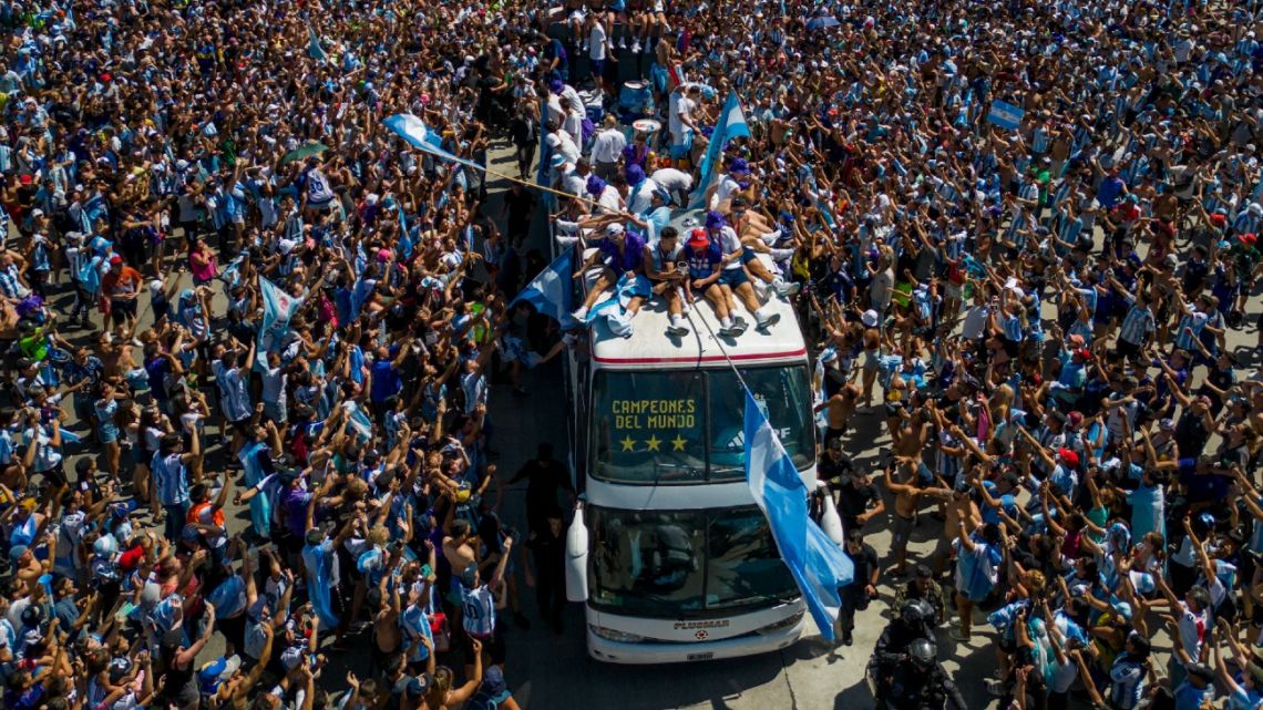 Argentina's players celebrate with supporters after winning the Qatar 2022 World Cup tournament as they tour through Buenos Aires and its surroundings on December 20, 2022. 