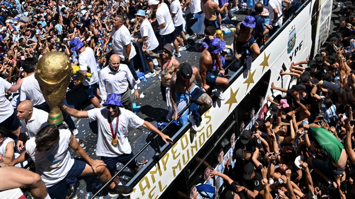 Fans of Argentina cheer as the team parades on board a bus after winning the Qatar 2022 World Cup tournament in Buenos Aires, Argentina on December 20, 2022.