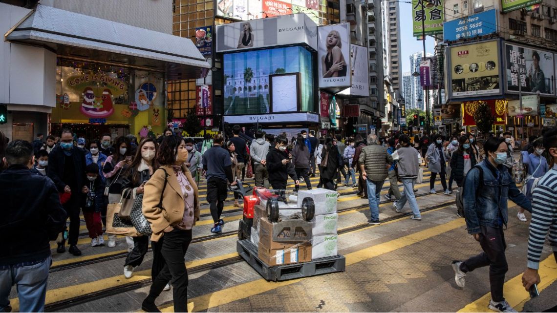 People walk through a shopping district in Hong Kong on December 22, 2022.