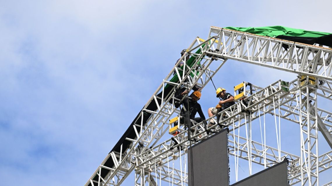 Workers set up the stage structure for the music festival that will be held on the inauguration day of Brazilian President-elect Luiz Inácio Lula da Silva at the Esplanade of Ministries in Brasilia, on December 27, 2022. Brazilian President-elect Luiz Inacio Lula da Silva's inauguration on January 1, 2023, will be secured by "100 percent" of the capital district's police force, an official said Tuesday amid widespread fears of violence. 