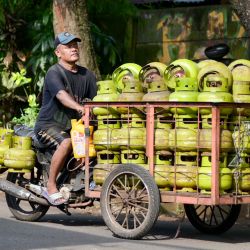 Un vendedor de garrafas de gas busca clientes en Yakarta, Indonesia. | Foto:BAY ISMOYO / AFP