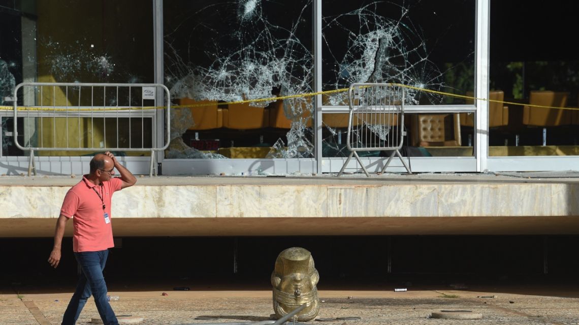 A man looks at damages at the Supreme Court building in Brasilia on January 10, 2023, two days after thousands of supporters of Brazil's far-right ex-president Jair Bolsonaro raided federal buildings.