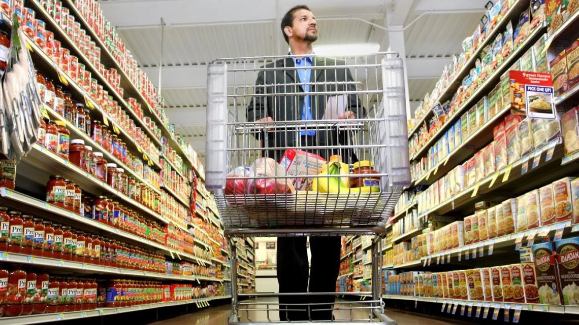 A shopper eyes up products at a supermarket.