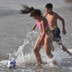 Chicos jugando al futbol en el mar de Pinamar, Argentina. Foto Pablo Cuarterolo | Foto:AFP