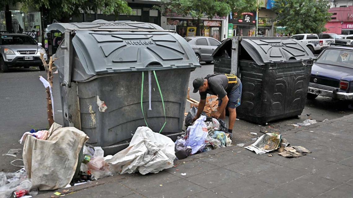 A man looks for recycling items in the trash on the street in Buenos Aires on January 12, 2023. 