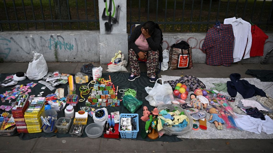A woman sells items on the street in Buenos Aires on January 12, 2023.