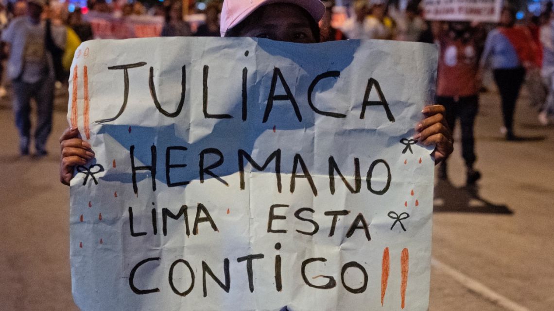 A woman holds a sign in support of the city of Juliaca during a march demandig the resignation of Peru's President Dina Boluarte and the closure of Congress, in a residential area in Lima, on January 15, 2023.