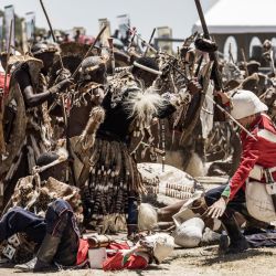 Regimientos zulúes Amabutho utilizan una lanza contra un soldado británico que cae durante la recreación de la Batalla de Isandlwana, en Isandlwana. - La recreación es llevada a cabo anualmente por los Amabutho y los Dundee Diehards, un equipo de voluntarios de Dundeed. La batalla, librada el 22 de enero de 1879, fue el primer gran enfrentamiento de la Guerra Anglo-Zulú entre el Imperio Británico y el Reino Zulú. | Foto:MARCO LONGARI / AFP