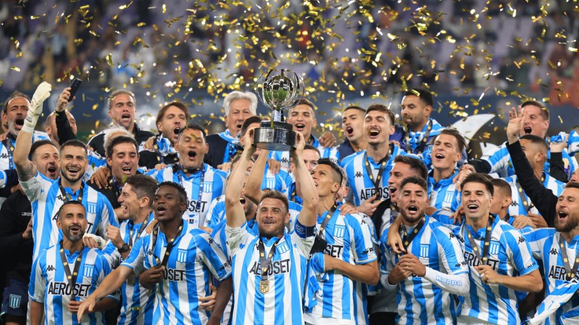 Racing Club's Argentine defender Ivan Pillud (C) carries the trophy after winning the 2022 Supercopa Internacional football match between Boca Juniors and Racing Club, at the Hazza bin Zayed Stadium in Al-Ain on January 20, 2023. 