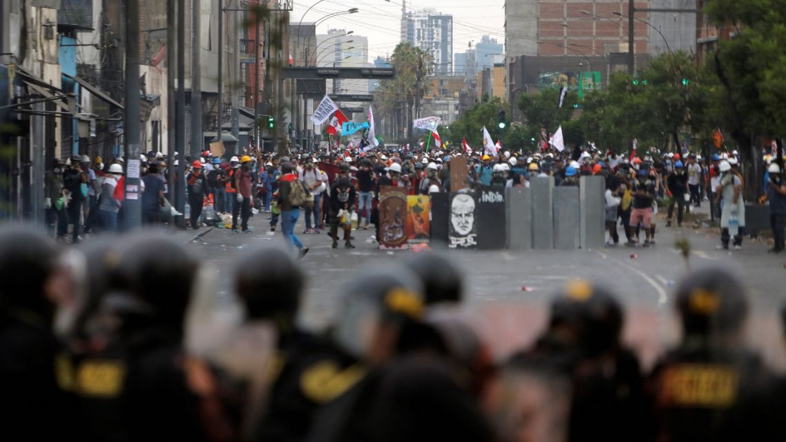 Demonstrators clash with riot police during a protest against the government of Peruvian President Dina Boluarte in Lima on January 28, 2023.