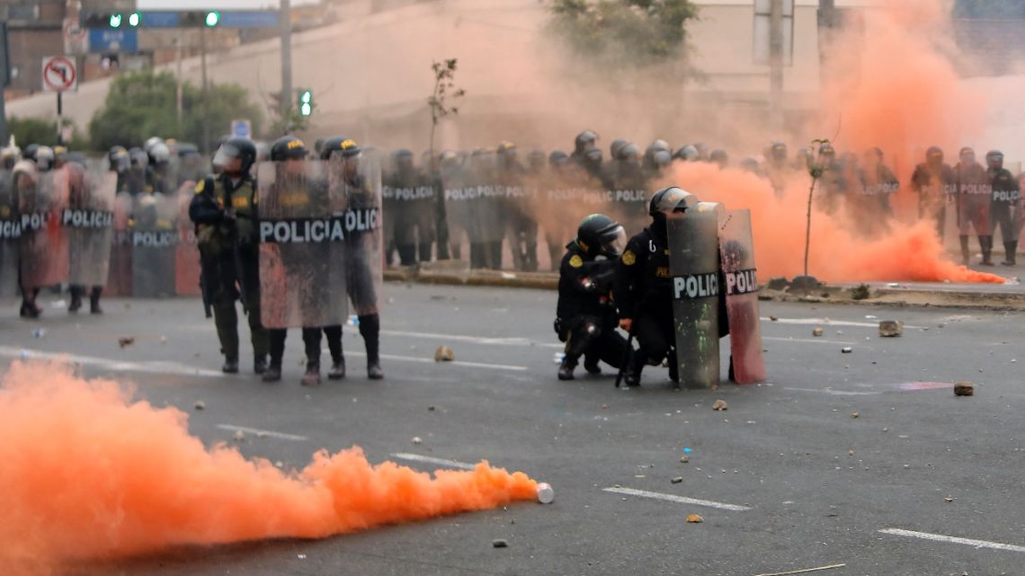 Riot police clash with demonstrators during a protest against the government of Peruvian President Dina Boluarte in Lima on January 28, 2023.