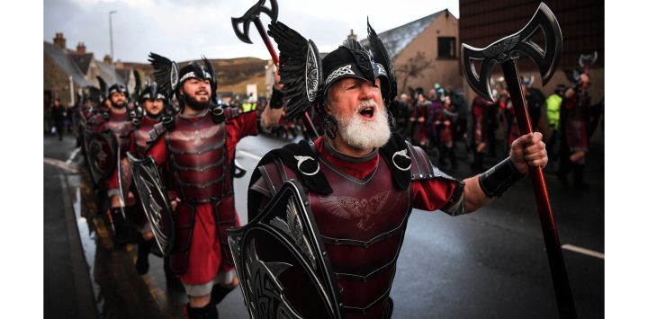 Miembros del "Escuadrón Jarl" de Up Helly Aa desfilan por las calles de Lerwick, antes del festival Up Helly Aa. - Up Helly Aa celebra la influencia de los vikingos escandinavos en las islas Shetland y culmina con hasta 1.000 "guizers" (hombres disfrazados) que lanzan antorchas encendidas a su lancha vikinga y le prenden fuego más tarde por la noche.
