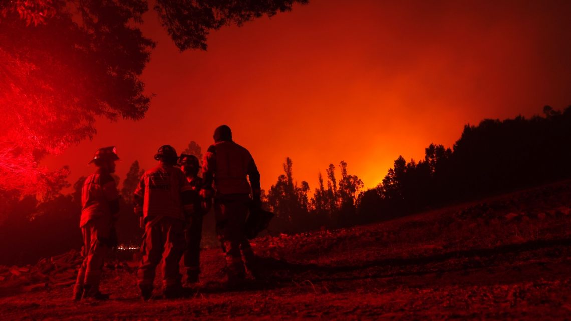 Firefighters are seen during a fire in Puren, Araucania region, Chile on February 4, 2023.