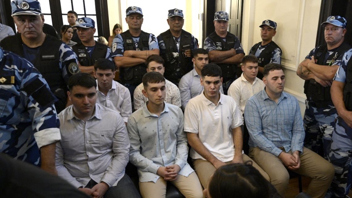 Defendants accused of the murder of Fernando Baez Sosa Ciro Pertossi (front, L), Matias Benicelli (front, 2-L), Blas Cinalli (front, 2-R), Lucas Pertossi (front, R), Ayrton Viollaz (back, L), Maximo Thomsen (back, 2-L), Enzo Comelli (back, 2-R) and Luciano Pertossi (back, R) hear their sentence at the court in Dolores, Buenos Aires province, Argentina on February 6, 2023.