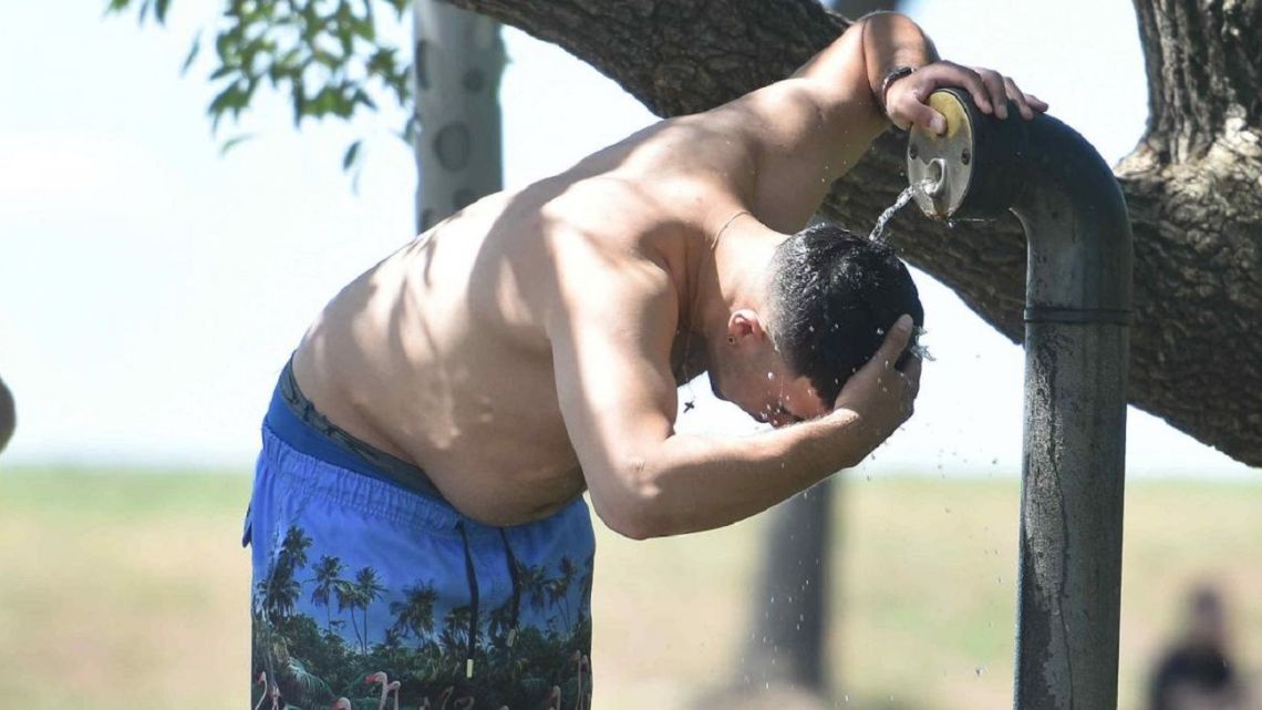 A man wets his head at a park in Buenos Aires amid a sweltering February heatwave.