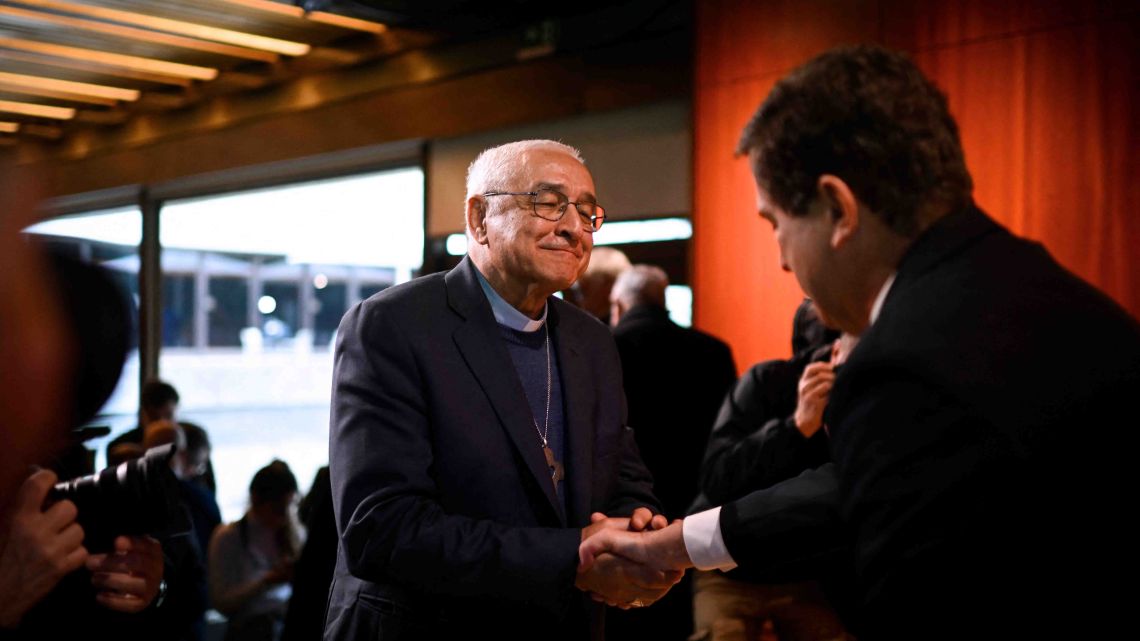 Jose Ornelas Carvalho (L), Bishop of Leiria-Fatima, shakes hands with Pedro Strecht (R), child psychiatrist and coordinator of the independent commission for the study of sexual abuse of children in the Portuguese Catholic Church, after the presentation of the commission's findings during a press conference at Gulbenkian Foundation in Lisbon, on February 13, 2023.
