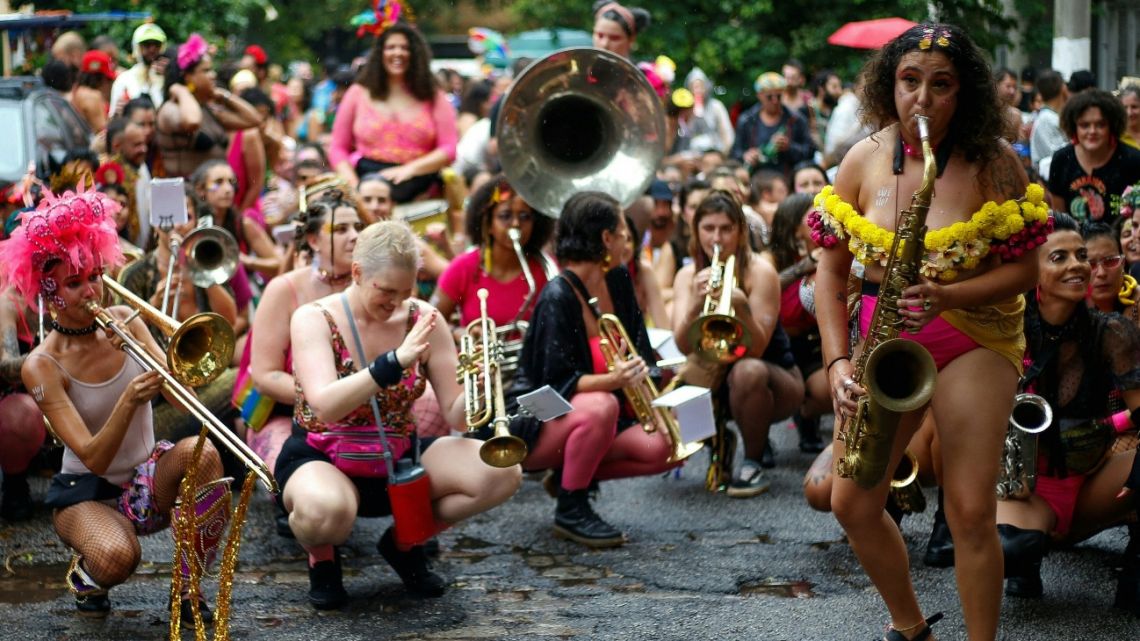 Revellers of the carnival group "Bloco das Obscenicas" play musical instruments during a street carnival parade in Sao Paulo, Brazil, on February 11, 2023. 