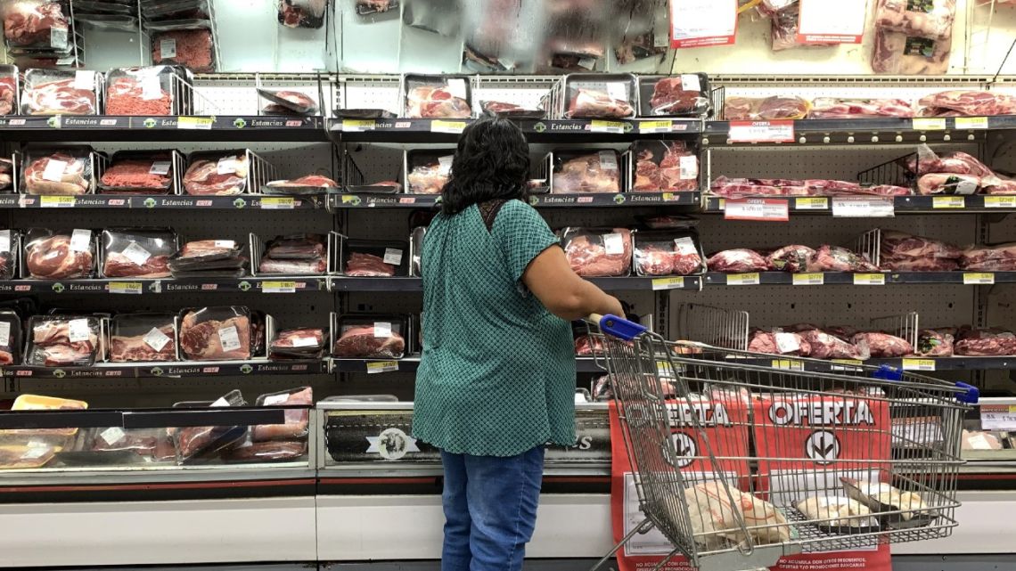 A customer looks at the prices of meat cuts at a supermarket in Buenos Aires on February 9, 2023,.