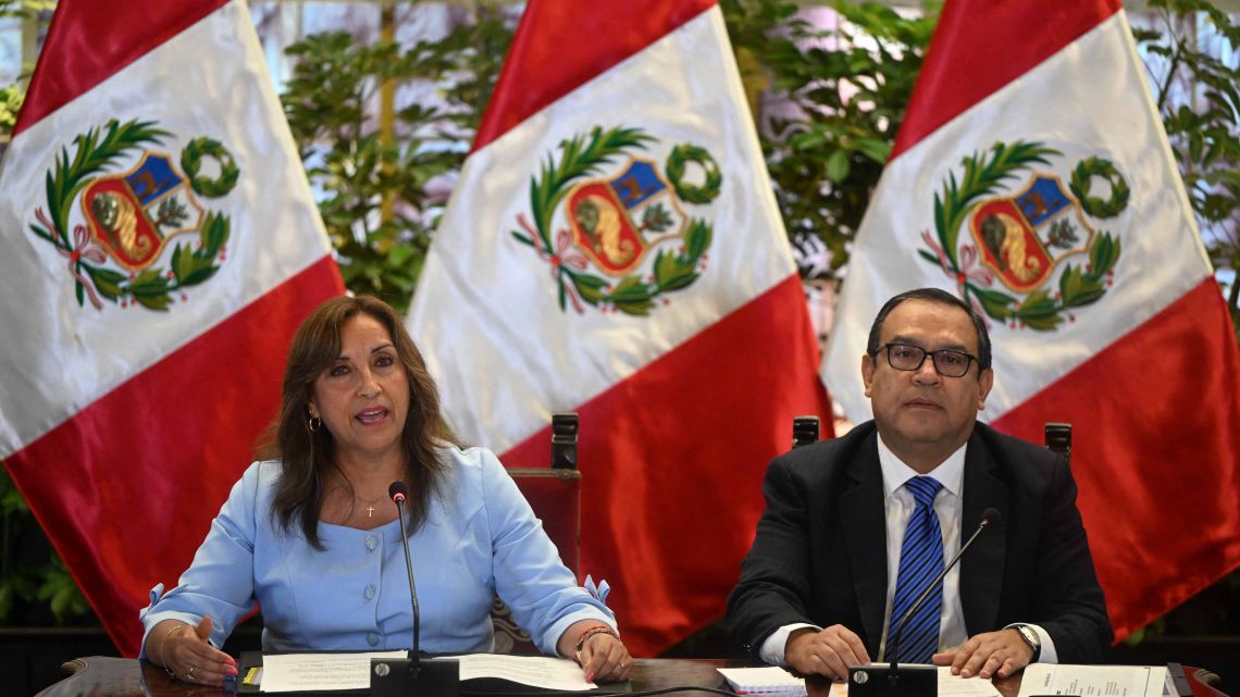 Peru's President Dina Boluarte (L) speaks next to Prime Minister Alberto Otarola during a press conference at the Presidential Palace in Lima on February 10, 2023.