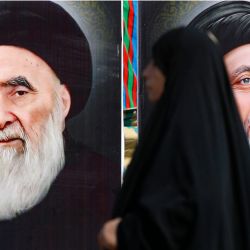 Una mujer iraquí camina junto a grandes retratos del clérigo chií supremo Ali al-Sistani y del difunto clérigo chií Muhammad Baqir al-Hakim, mientras los peregrinos marchan desde el centro de Bagdad hacia el santuario del imán Musa al-Kadhim, del siglo VIII, en el distrito de Kadhimiya, al norte de la capital. | Foto:AHMAD AL-RUBAYE / AFP
