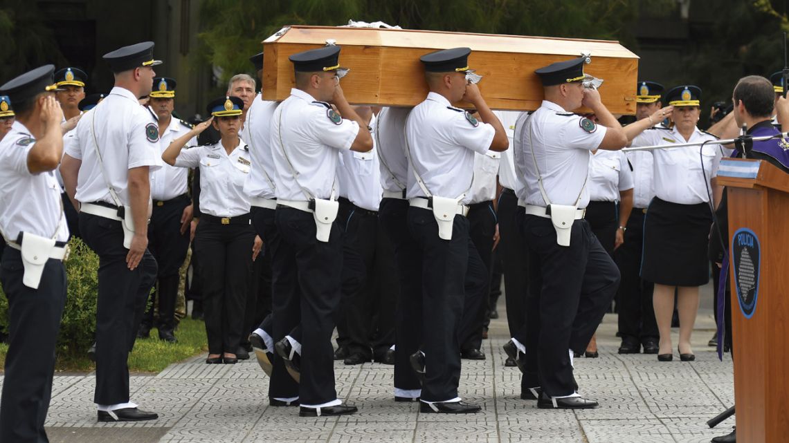 Police authorities, officers and relatives of the victim attend the funeral at Chacarita Cemetery.