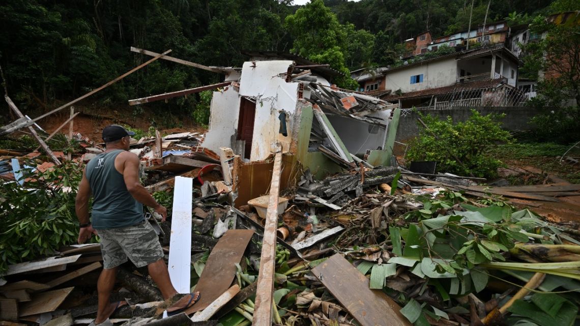 A man walks amid debris at a flood-affected area in the Juquehy district in São Sebastião, Brazil, on February 20, 2023.