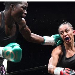 La francesa Estelle Mossely compite contra la malauí Anisha Basheel durante su pelea por el título femenino de peso ligero de la Organización Internacional de Boxeo (OIB) en la Salle Wagram de París. | Foto:EMMANUEL DUNAND / AFP