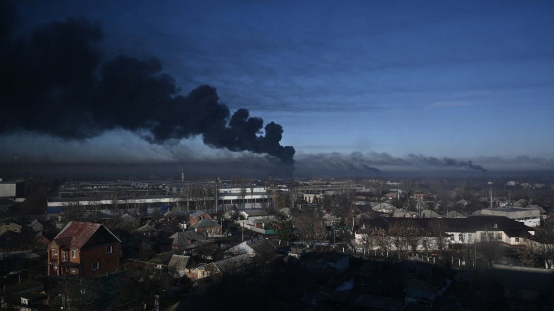 In this file photo taken on February 24, 2022 black smoke rises from a military airport in Chuguyev near Kharkiv during the Russian invasion.