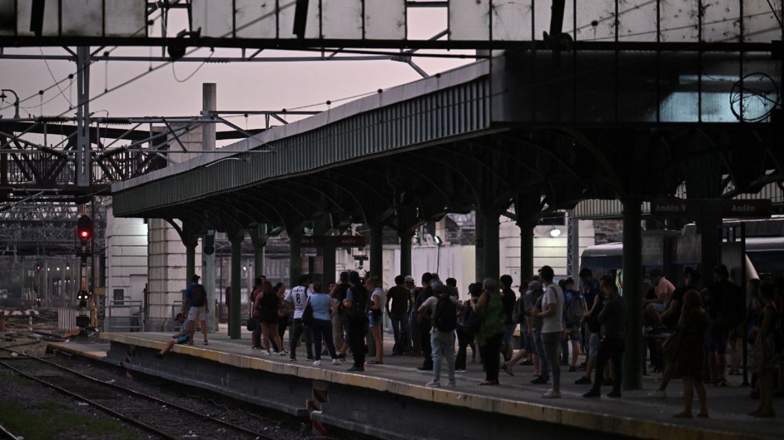 People wait at the Constitución train station in Buenos Aires on March 1, 2023, following an outage caused by a fire which affected the high-voltage system. 