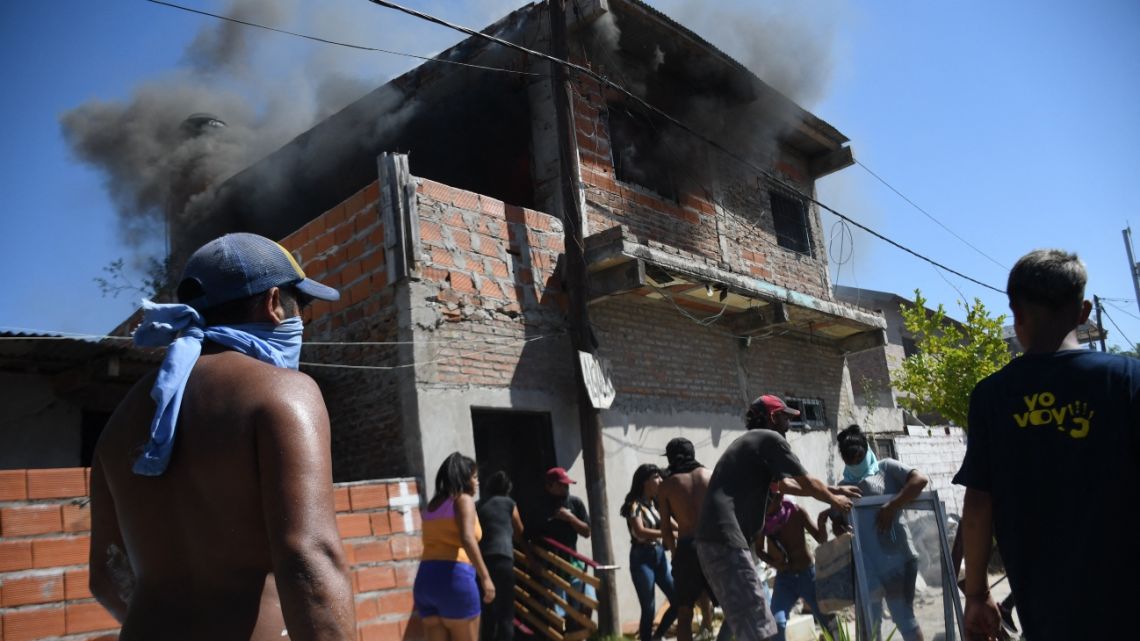 People loot and destroy the house of an alleged drug trafficker in Rosario, Santa Fe province, on March 6, 2023, in protests over the killing of a child in the middle of a shooting while playing in the street last Saturday night. 