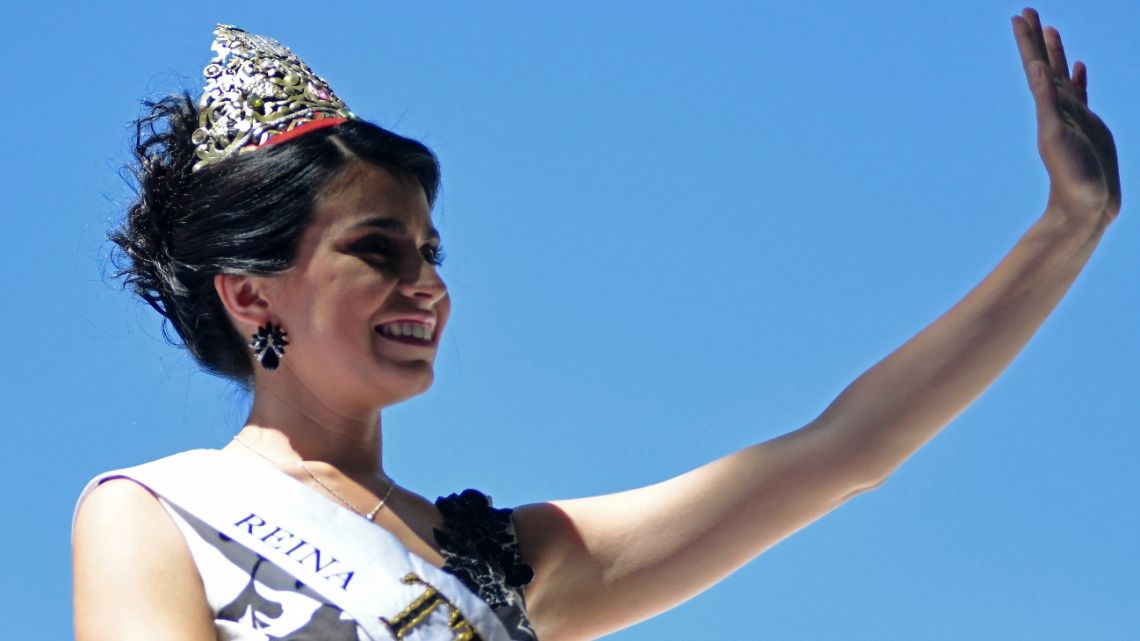 Gemina Navarro, queen of Mendoza's department Tupungato, waves during the El Carrusel parade, one of the main events of the Fiesta de la Vendimia celebrations, in Mendoza, Argentina, on March 4, 2023