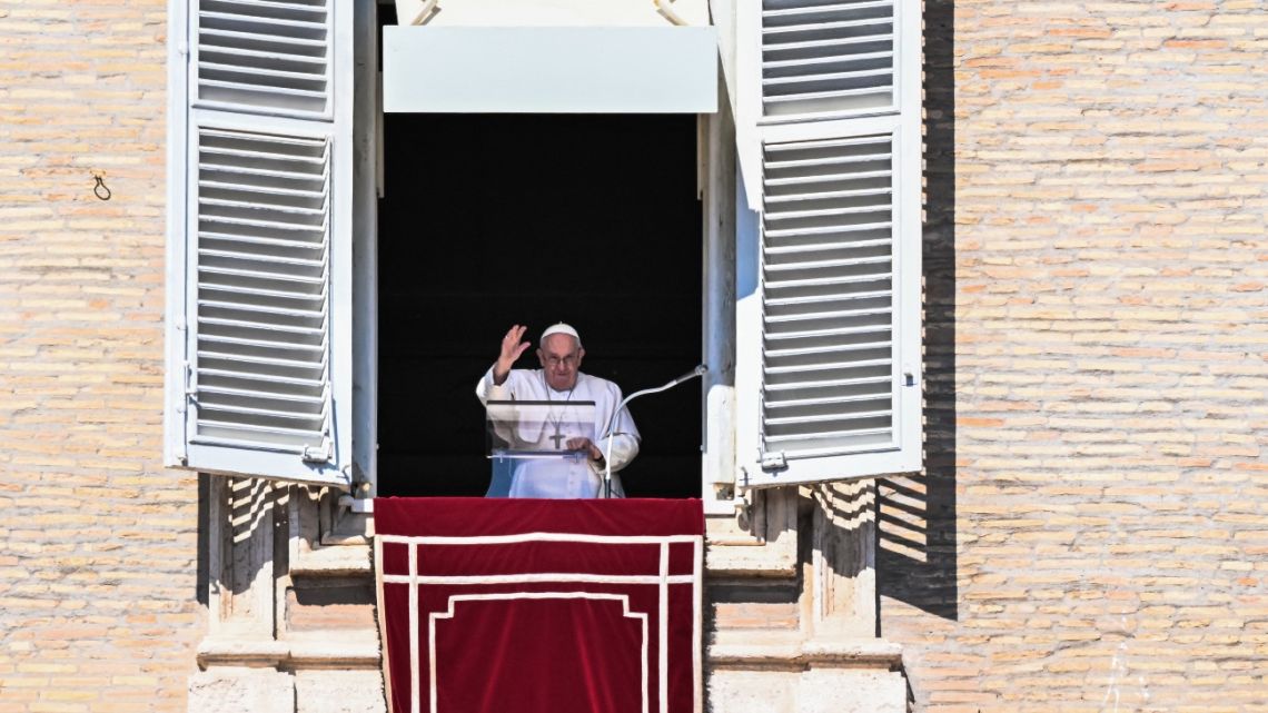 Pope Francis waves from the window of the apostolic palace during the weekly Angelus prayer on March 12, 2023 in The Vatican. 