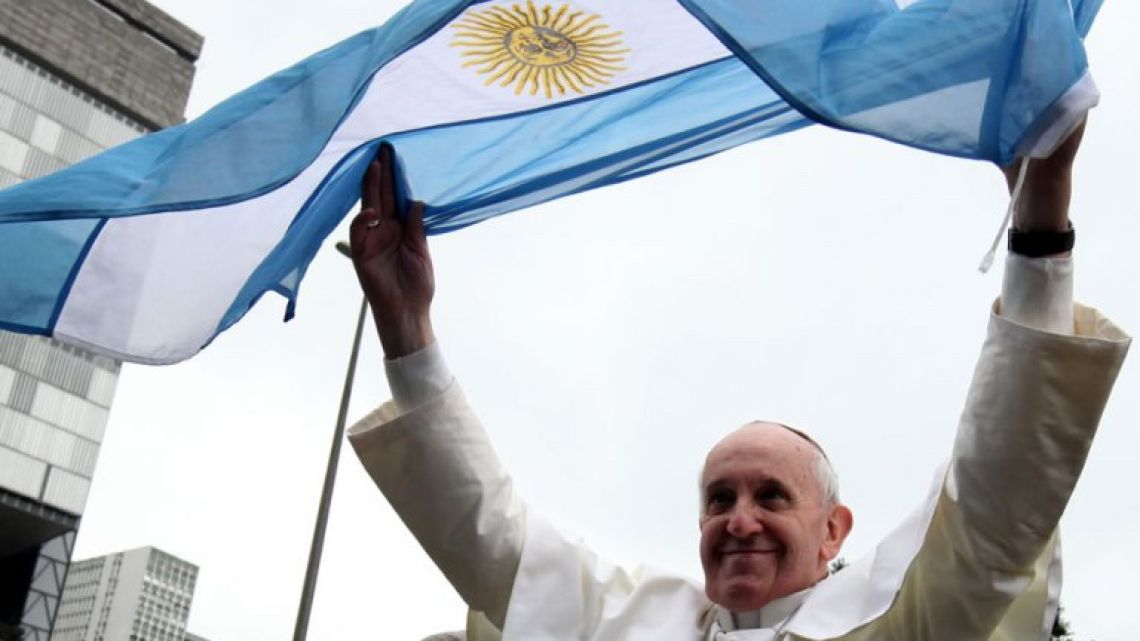Pope Francis waves an Argentine flag.