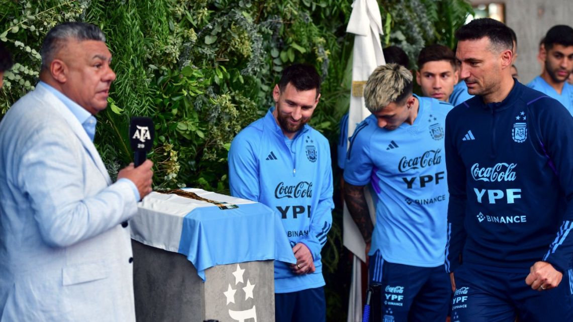 Handout picture released by Telám shows the president of the Argentine Football Association (AFA) Claudio Tapia delivering a speech next to Argentina's forward Lionel Messi, defender Lisandro Martínez and coach Lionel Scaloni before unveiling a plaque during the renaming of AFA's training camp as 'Lionel Andrés Messi' in honour of the star, in Ezeiza, Buenos Aires Province, on March 25, 2023.