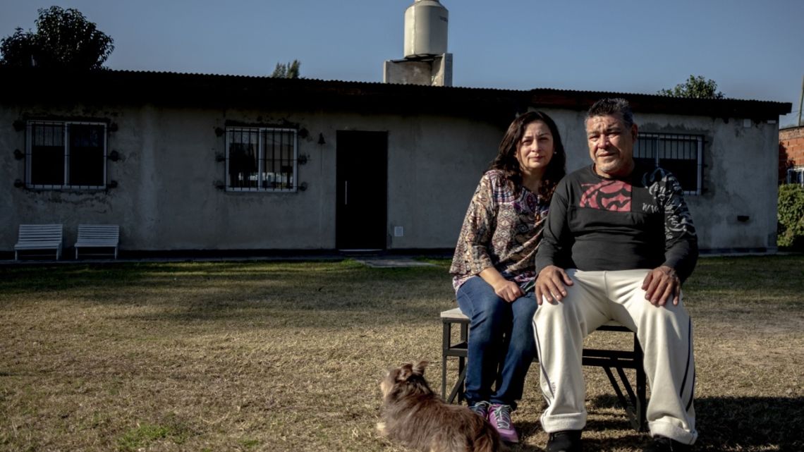 uan Carlos Moyano, who went from a 15-year salaried career as a security guard and maintenance manager to odd jobs around Buenos Aires that pay $1 an hour, and his wife Mabel Alvarez in front of their home in Benavidez, Argentina, on Friday, July 23, 2021.