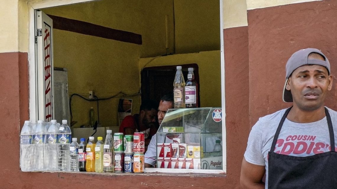 Owners of a small private street stall wait for customers, on March 31, 2023, in Havana