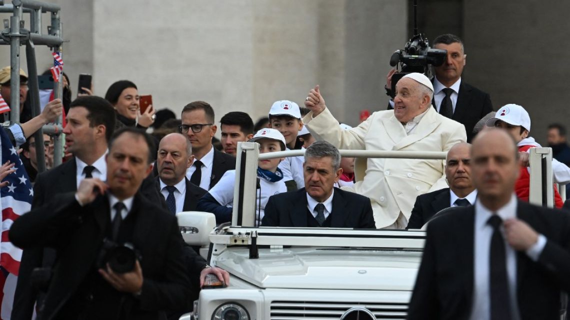 Pope Francis gestures towards attendees as he arrives in the popemobile car to hold the weekly general audience on April 5, 2023 at St. Peter's square in The Vatican.