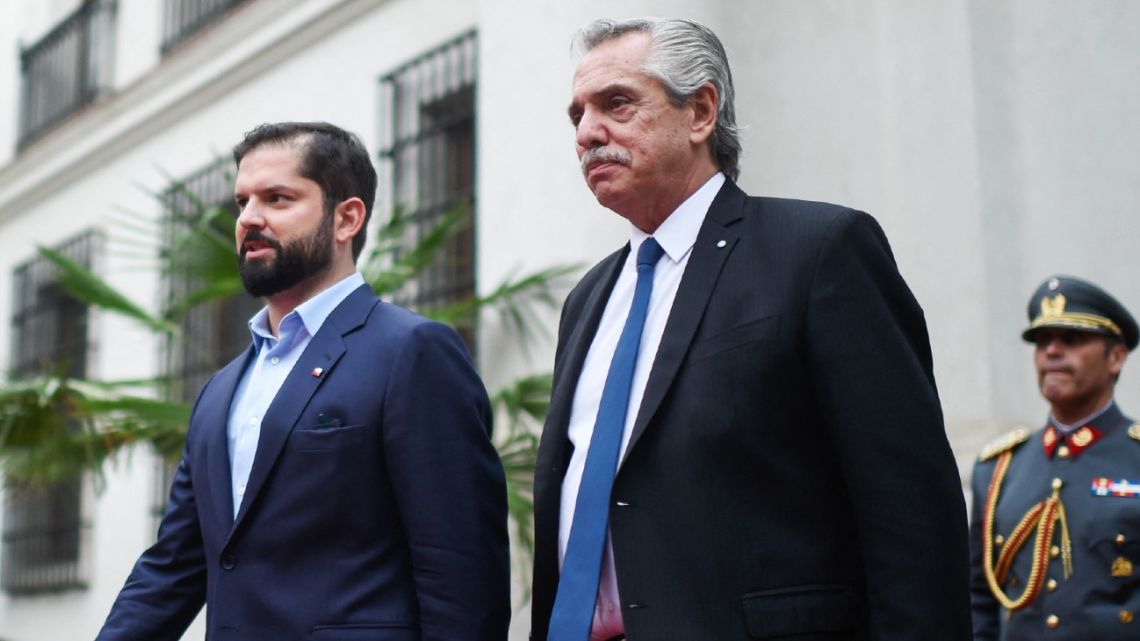 Chilean President Gabriel Boric and Argentina's President Alberto Fernández leave the Palacio de La Moneda in Santiago on April 5, 2023. 