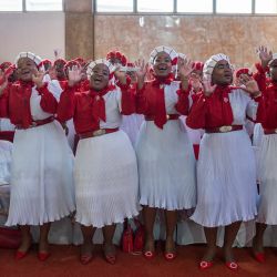Los fieles cantan y bailan en la Iglesia de la Santidad Pentecostal Internacional de Zuurbekom, al sur de Johannesburgo, antes de una ceremonia nupcial multitudinaria en la que se casaron 80 parejas. | Foto:IHSAAN HAFFEJEE / AFP