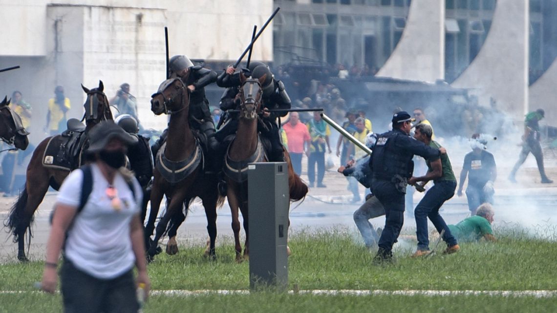 Supporters of Brazilian former President Jair Bolsonaro clash with security forces during an invasion to Planalto Presidential Palace in Brasilia on January 08, 2023.